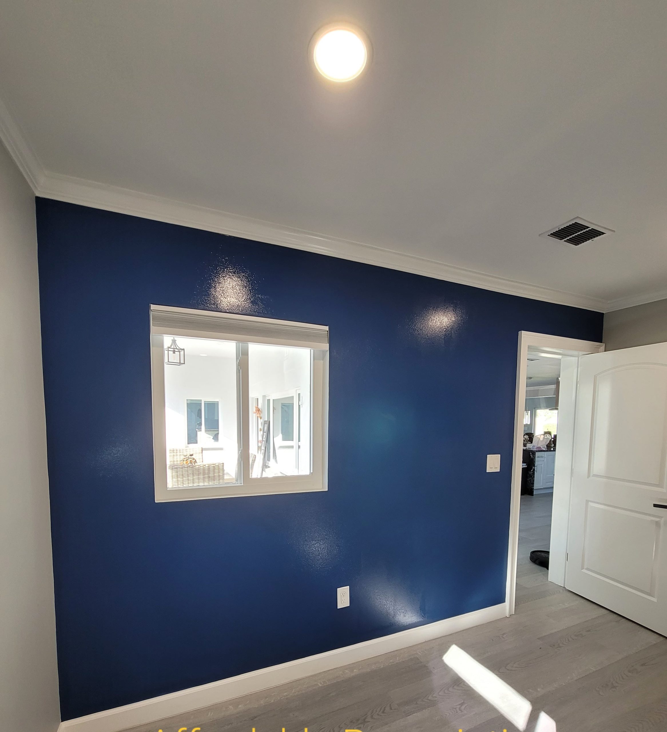 Navy-Blue-Accent-Wall-With-White-Window-Trim